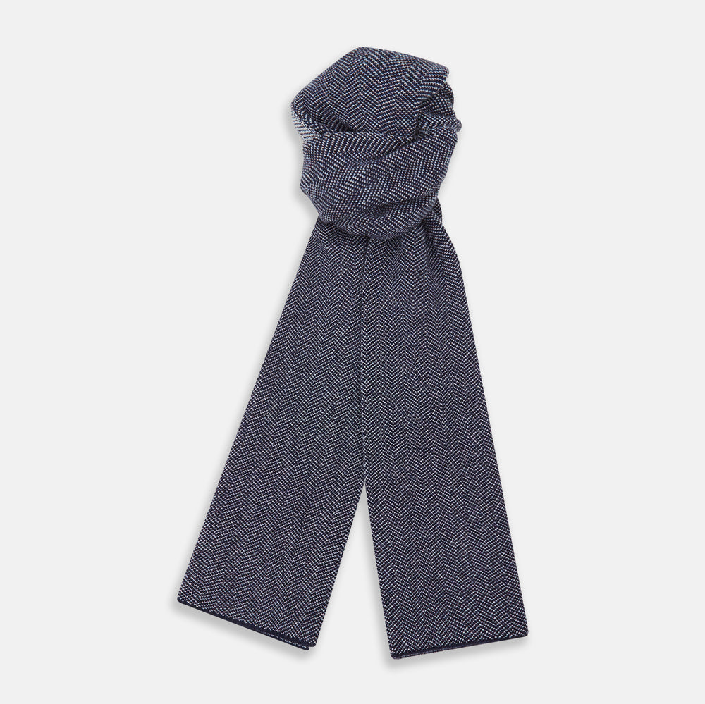 The Turnbull & Asser Reversible Navy and White Herringbone Cashmere Scarf is a timeless winter accessory, featuring an elegant two-tone pattern and luxurious softness.