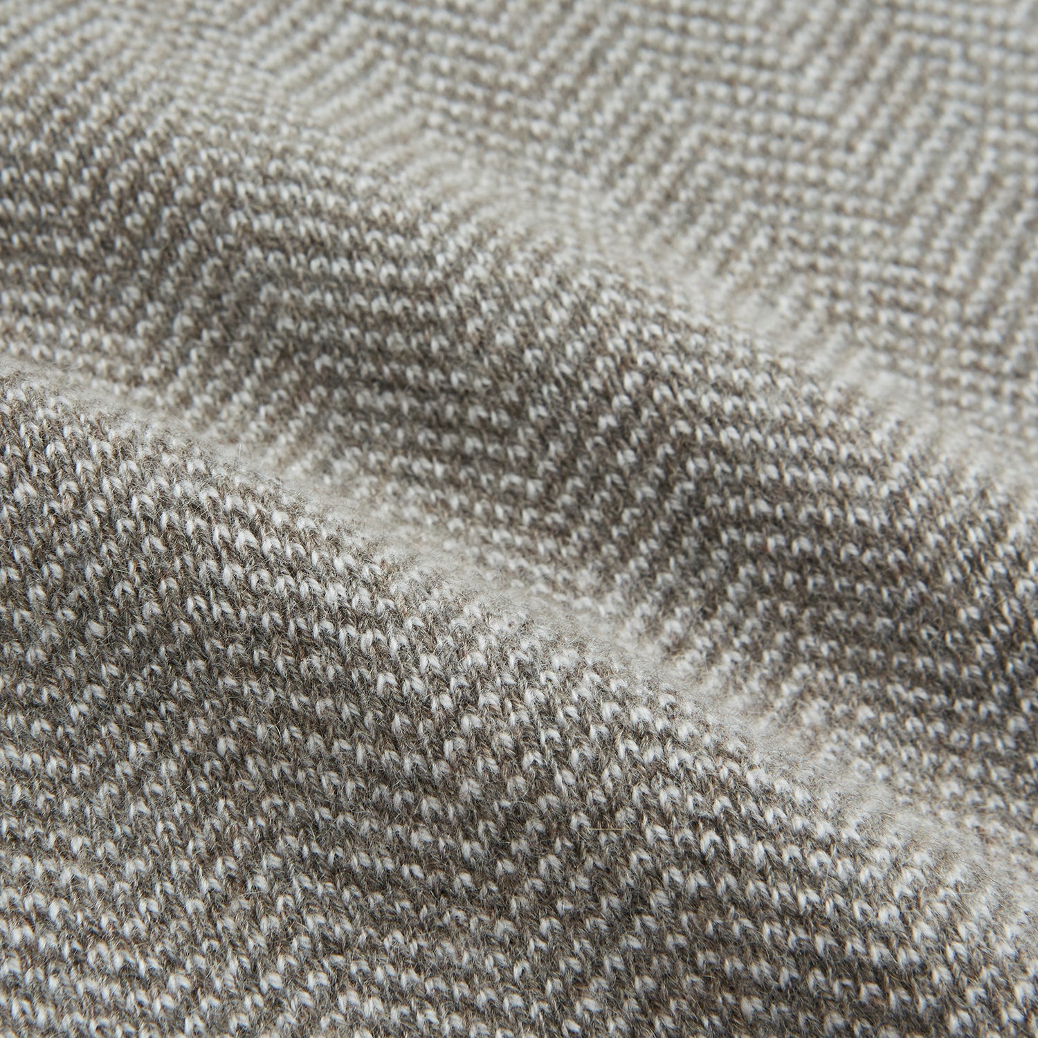 View 3 of product The Turnbull & Asser Reversible Grey Herringbone Cashmere Scarf is artfully folded and displayed on a plain white background.