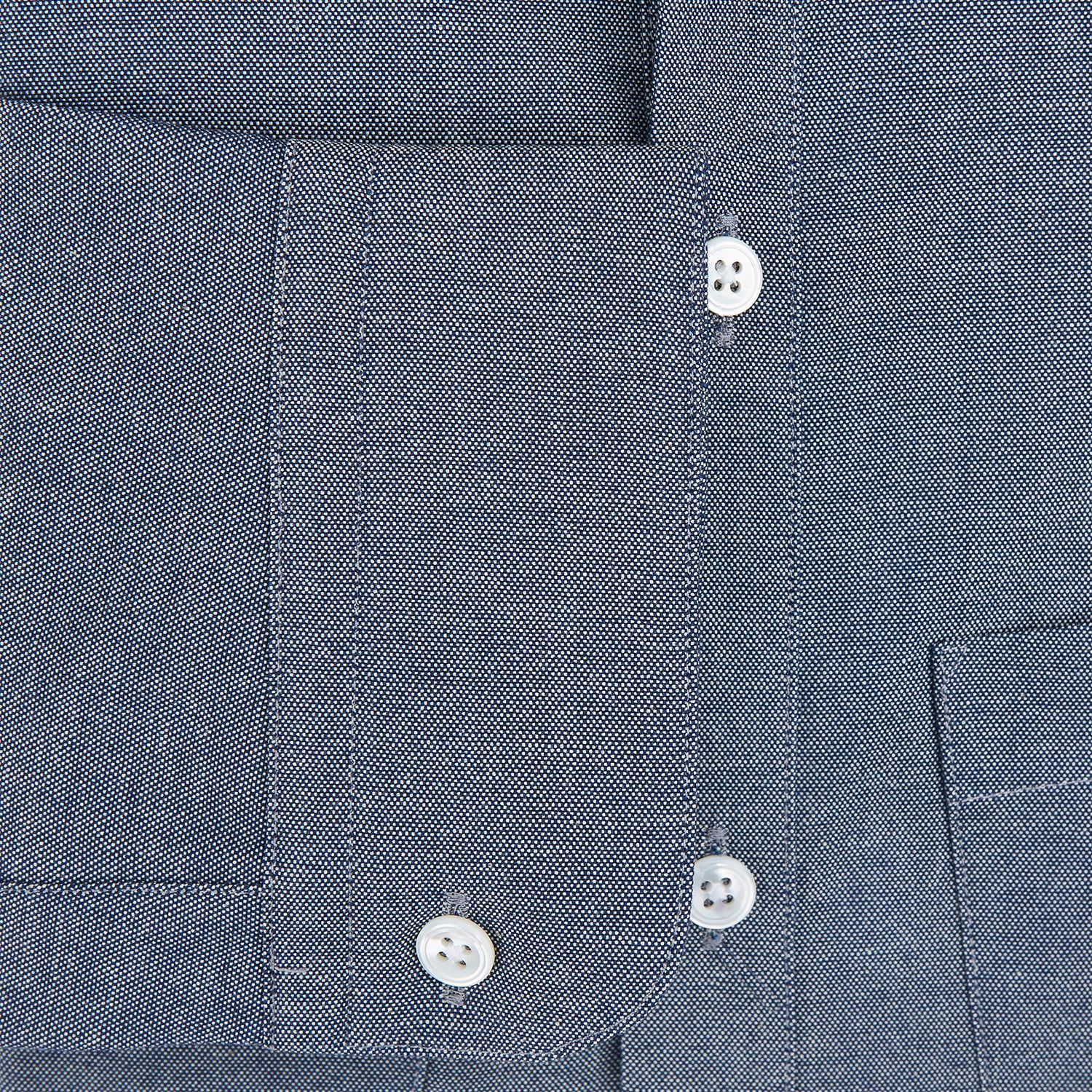 View 3 of product The Turnbull & Asser Steel Blue Piccadilly Shirt features long sleeves, a button-up front, two chest pockets, and white buttons, shown against a plain white background.