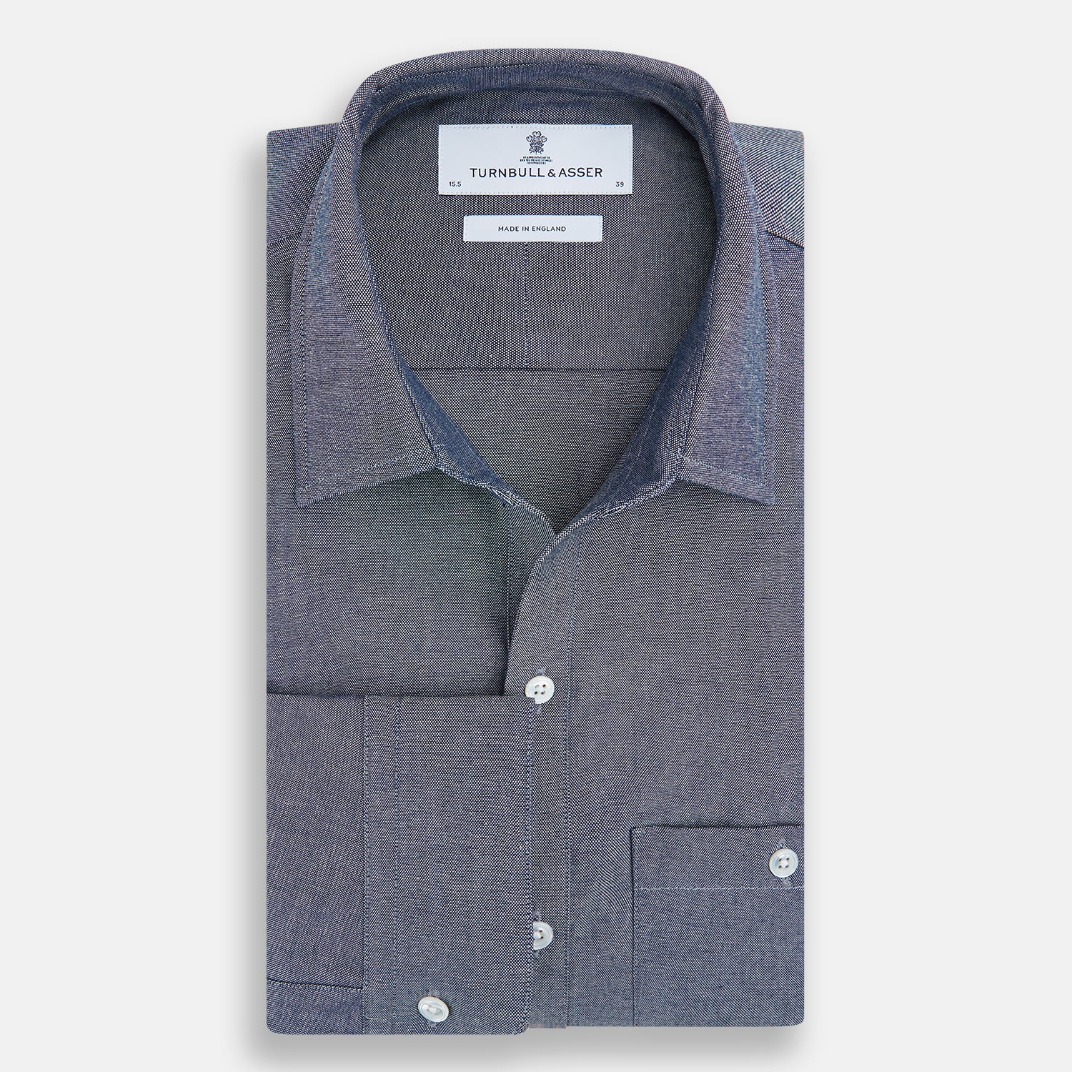 View 5 of product The Turnbull & Asser Steel Blue Piccadilly Shirt features long sleeves, a button-up front, two chest pockets, and white buttons, shown against a plain white background.