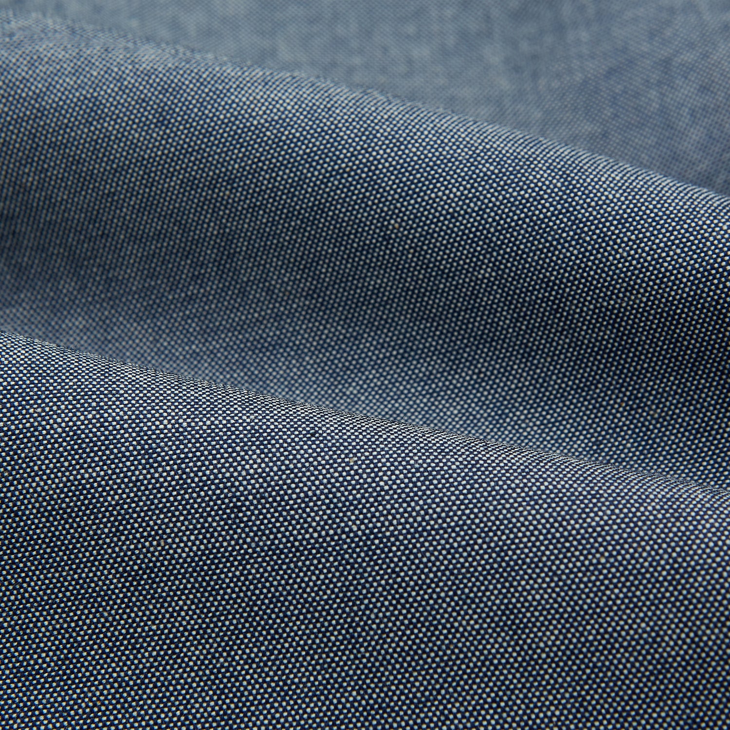 View 6 of product The Turnbull & Asser Steel Blue Piccadilly Shirt features long sleeves, a button-up front, two chest pockets, and white buttons, shown against a plain white background.