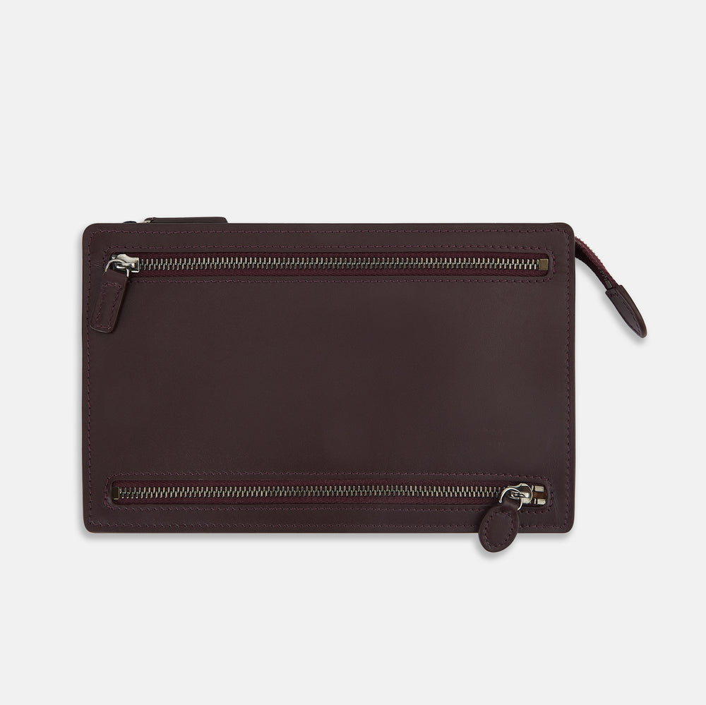 The Turnbull & Asser UK Burgundy Leather Zip Envelope Pouch features two horizontal zipper compartments with matching leather pulls, making it a stylish travel accessory or passport holder.