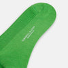 View 3 of product A single Bright Green Mid-Length Merino Sock by Turnbull & Asser is displayed standing with the heel slightly lifted against a plain white background.