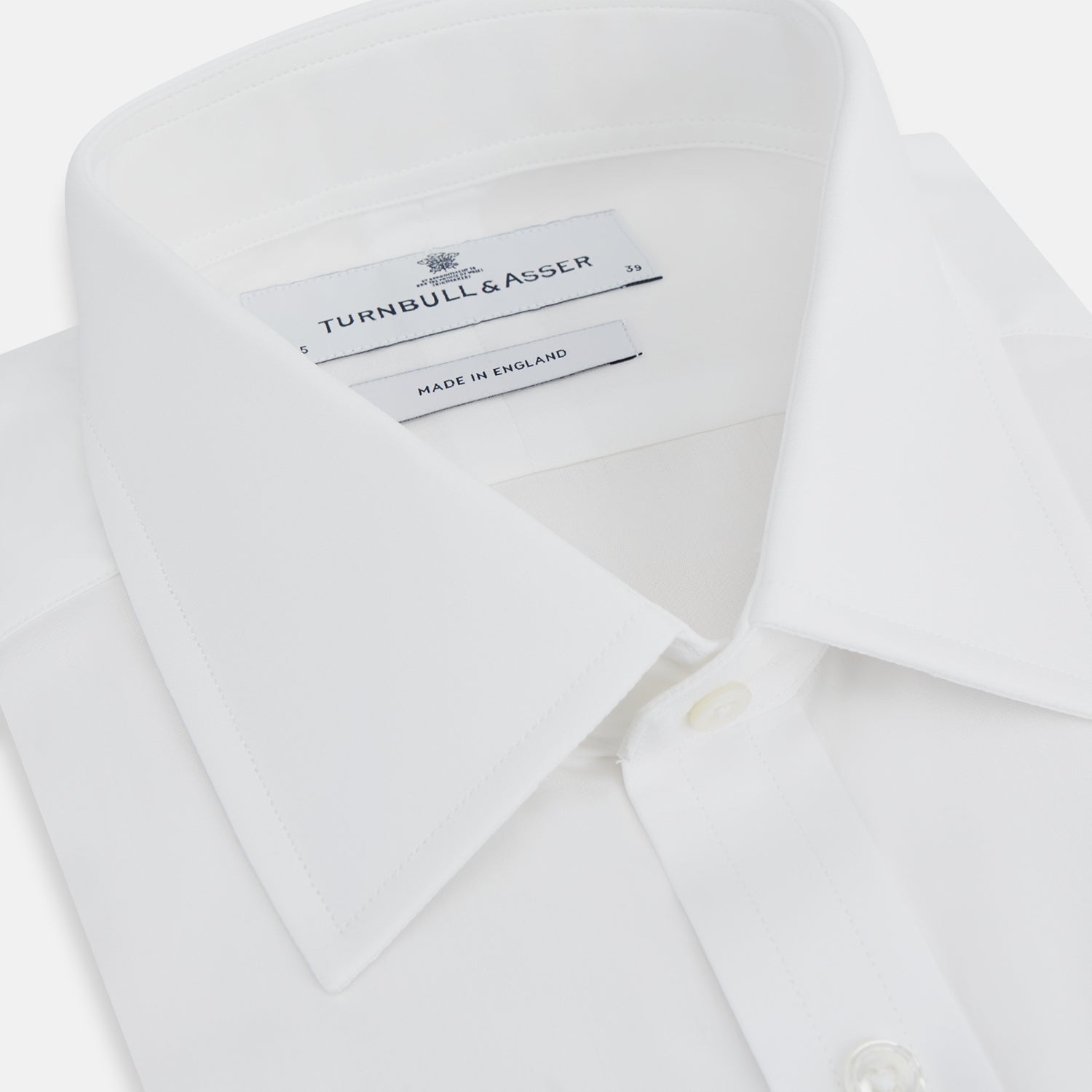 View 2 of product The Turnbull & Asser Plain White Cotton Shirt features a T&A collar, 3-button cuffs, and a timeless minimalist design, shown on a plain white background.