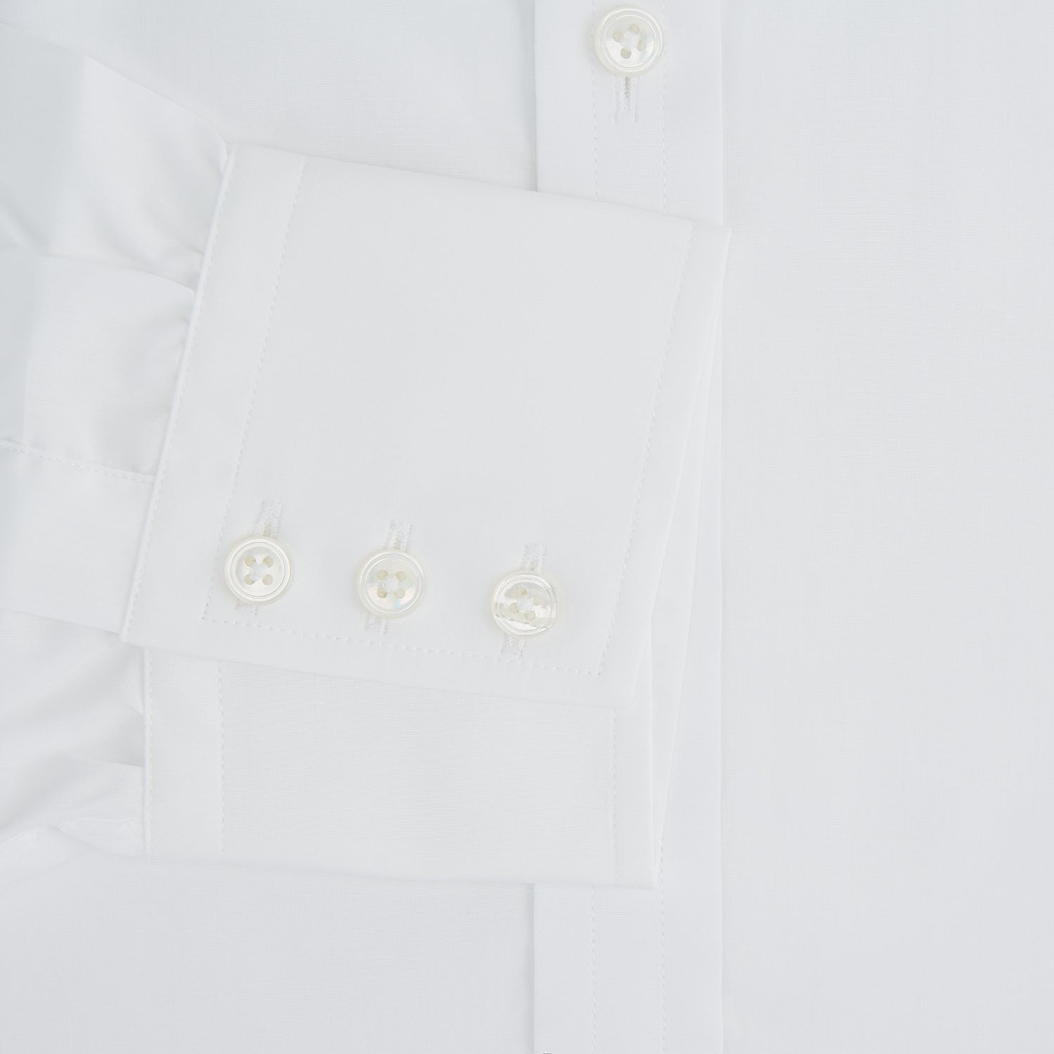 View 4 of product The Turnbull & Asser Plain White Cotton Shirt features a T&A collar, 3-button cuffs, and a timeless minimalist design, shown on a plain white background.