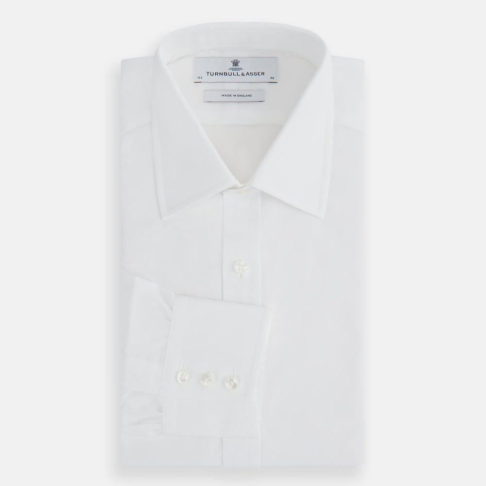 The Turnbull & Asser Plain White Cotton Shirt features a T&A collar, 3-button cuffs, and a timeless minimalist design, shown on a plain white background.