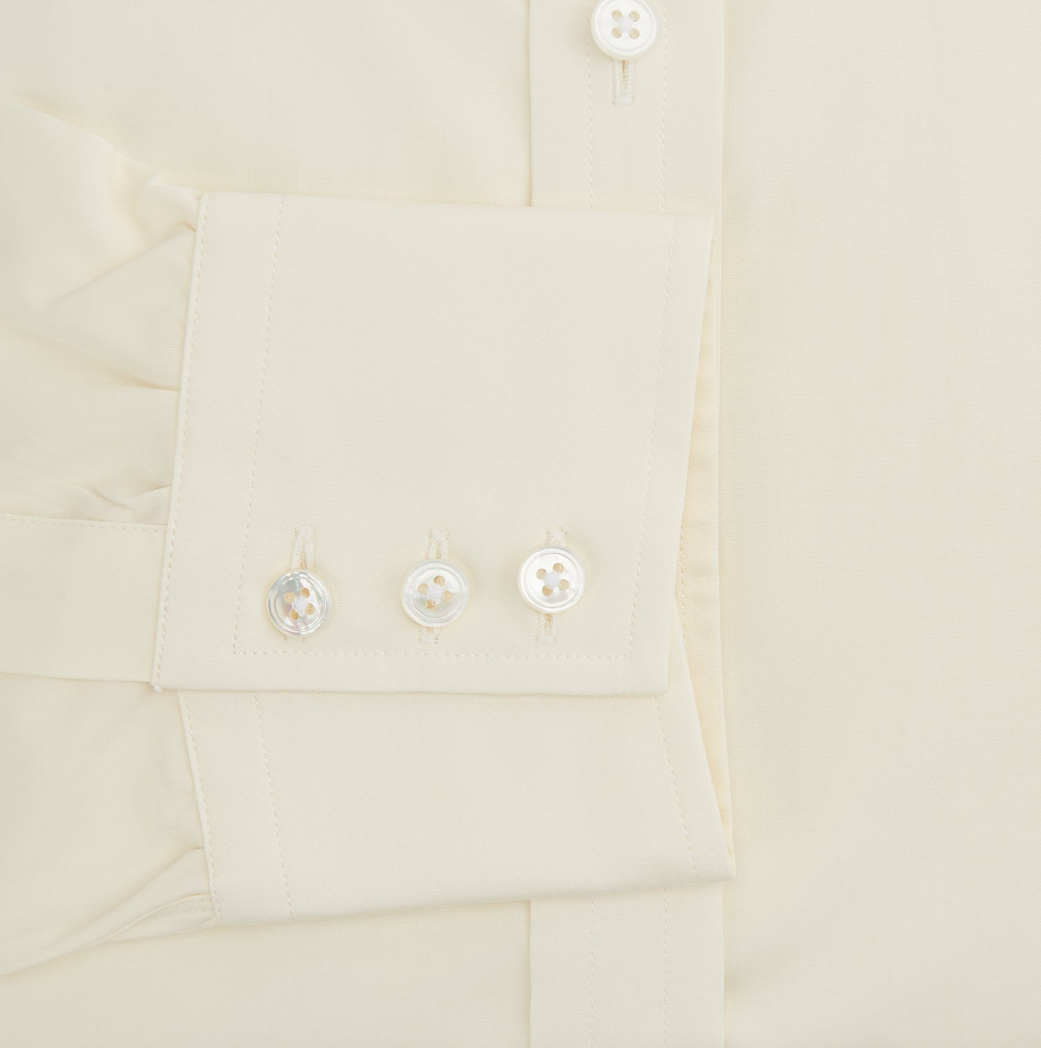 View 4 of product The Turnbull & Asser Cream Cotton Shirt features a T&A collar, button-up front, and 3-button cuffs, displayed on a plain white background.
