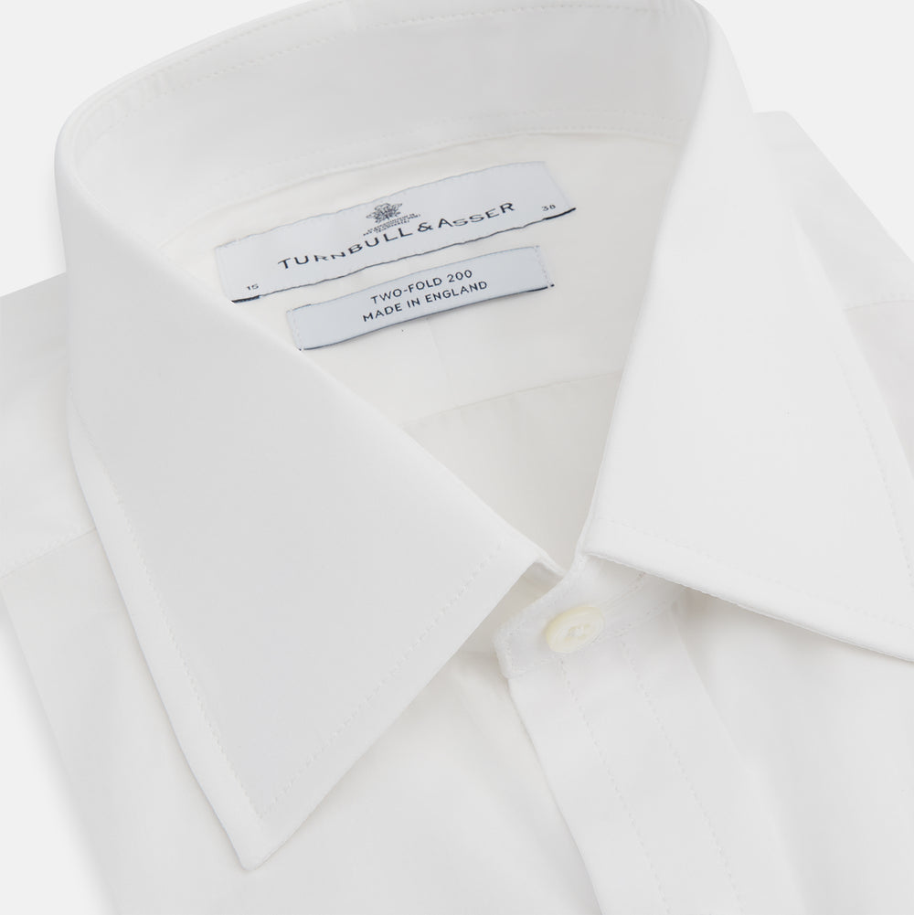 The Turnbull & Asser Two-Fold 200 White Cotton Shirt features a T&A collar and 3-button cuffs, crafted from breathable cotton and shown on a plain white background.