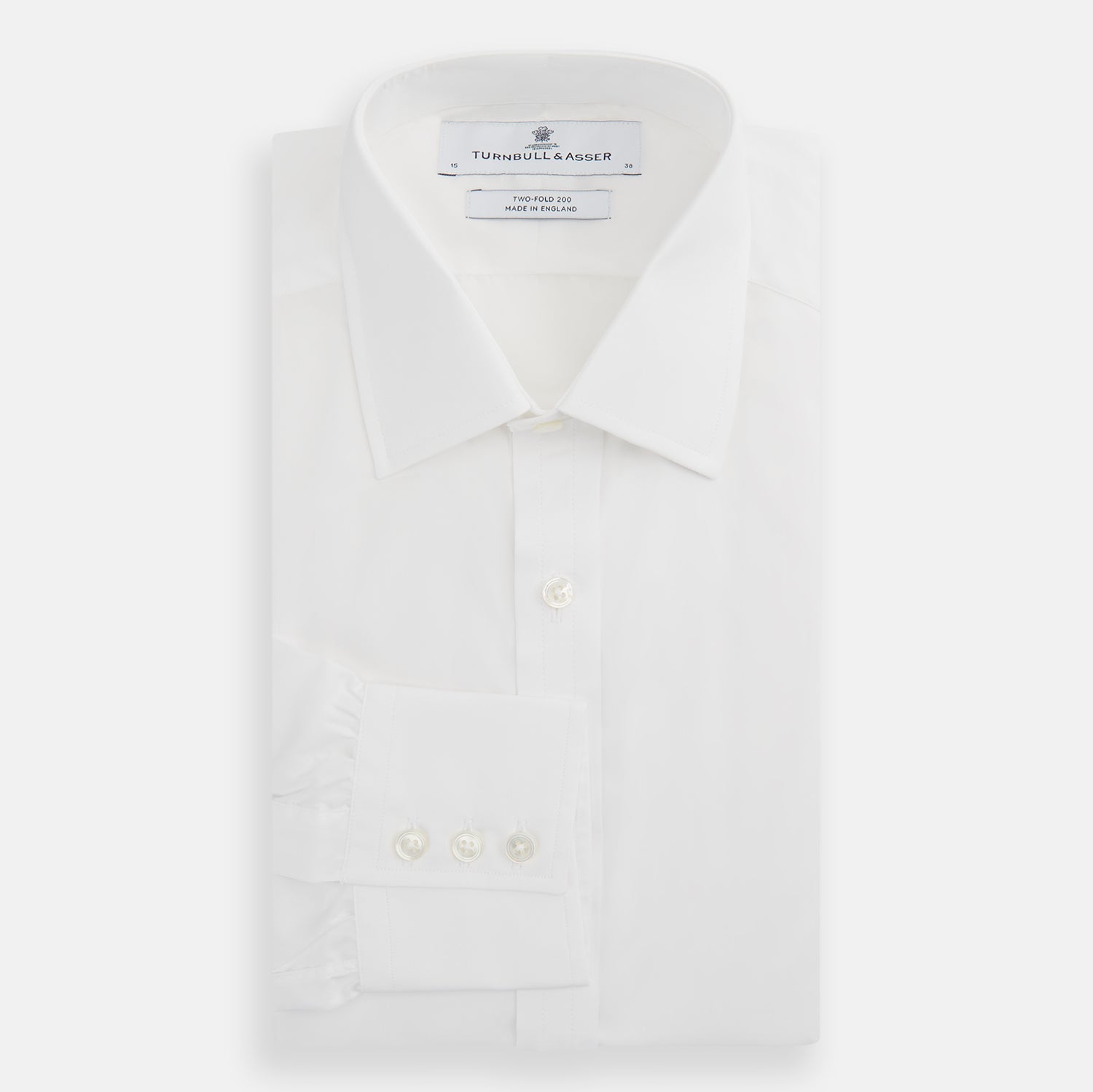 View 4 of product The Turnbull & Asser Two-Fold 200 White Cotton Shirt features a T&A collar and 3-button cuffs, crafted from breathable cotton and shown on a plain white background.