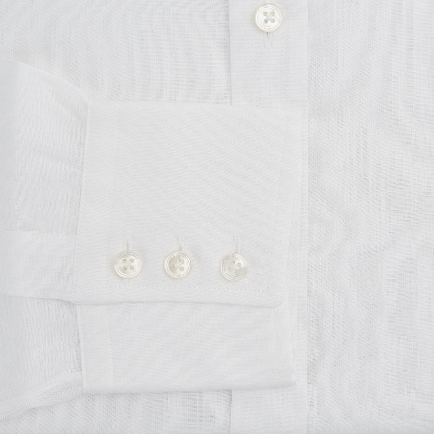 View 3 of product The Turnbull & Asser White Linen Shirt features a T&A collar and 3-button cuffs—an essential summer staple, shown here laid flat on a white background.