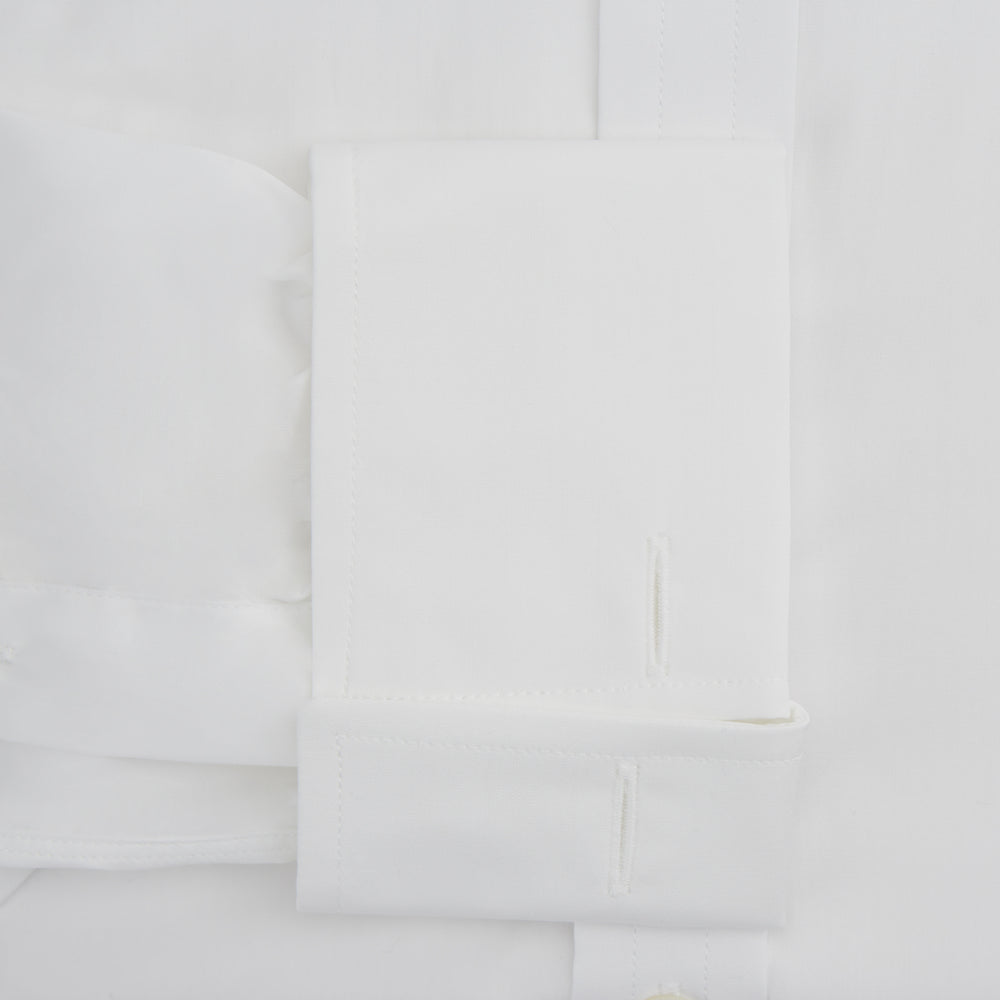 The Turnbull & Asser White Sea Island Quality Cotton Shirt features a T&A collar and double cuffs, crafted from premium cotton and shown laid flat against a white background.