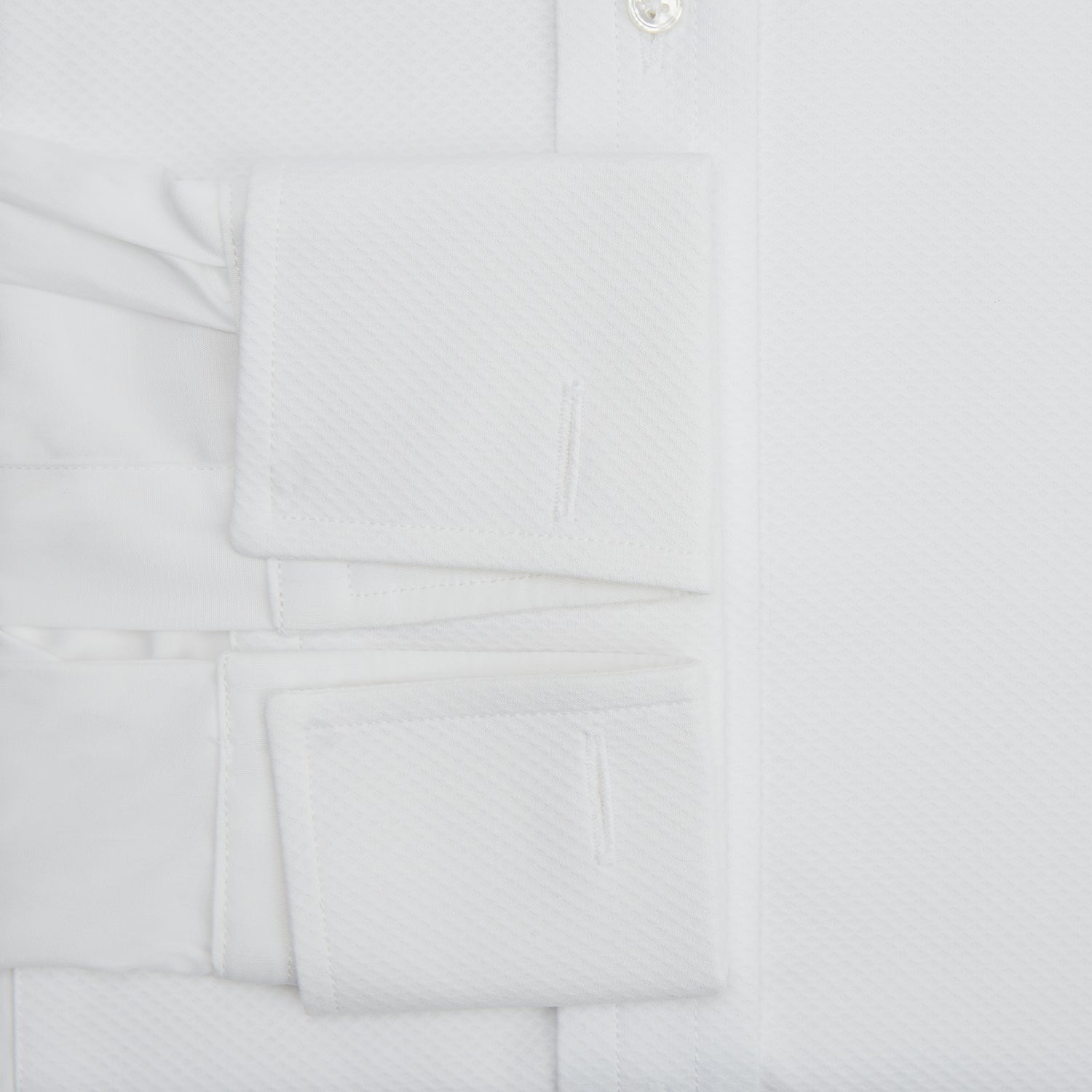 View 3 of product The Turnbull & Asser White Marcella Dress Shirt features a T&A collar, double cuffs, a classic bib front, and a button-down design—ideal for formal occasions. Displayed against a plain white background.