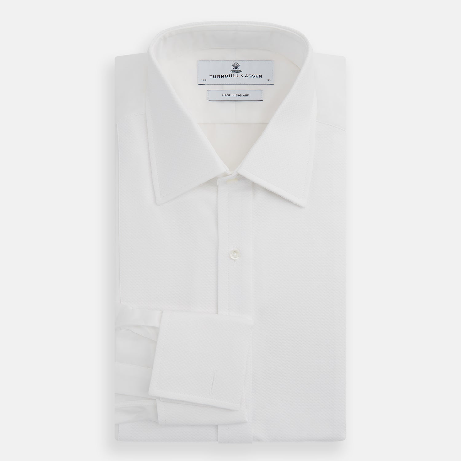 View 4 of product The Turnbull & Asser White Marcella Dress Shirt features a T&A collar, double cuffs, a classic bib front, and a button-down design—ideal for formal occasions. Displayed against a plain white background.