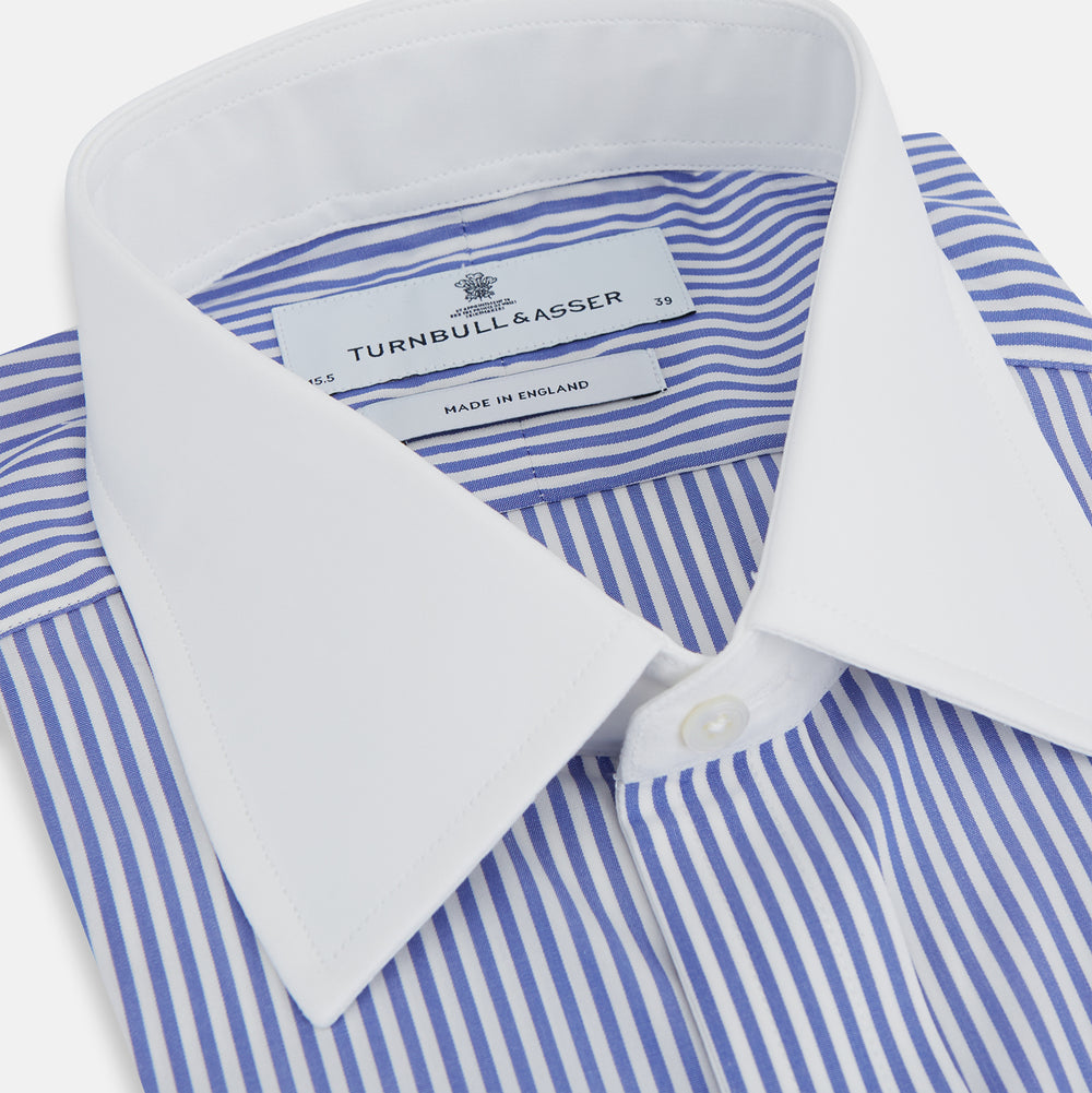 The Gekko Shirt with Contrast T&A Collar and Double Cuffs by Turnbull & Asser features blue and white vertical stripes, a white collar, and double cuffs, inspired by the Wall Street film. Displayed on a plain white background.