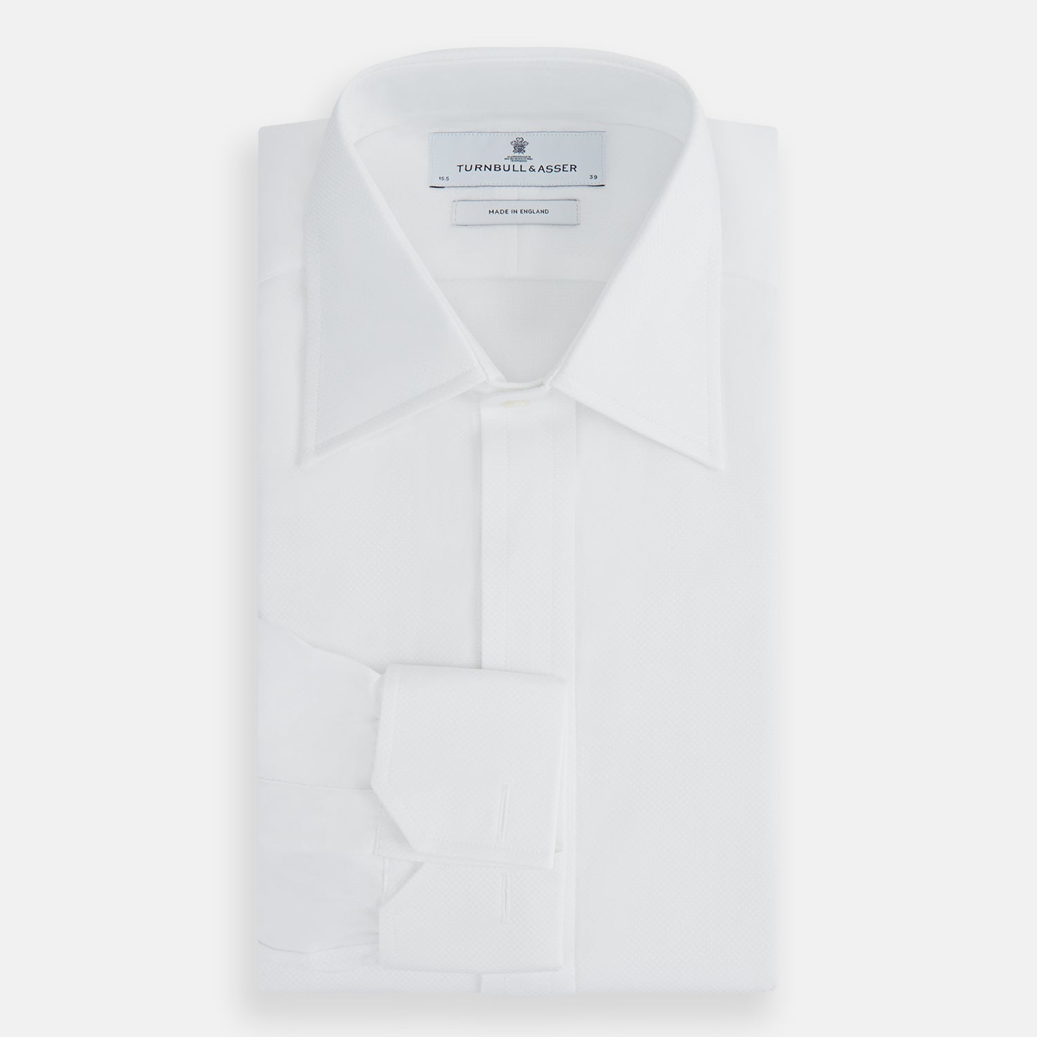 View 5 of product The Turnbull & Asser Casino Royale White Dress Shirt, as seen on James Bond, features long sleeves, a button-down front, and classic collar and cuffs. Displayed against a plain white background.