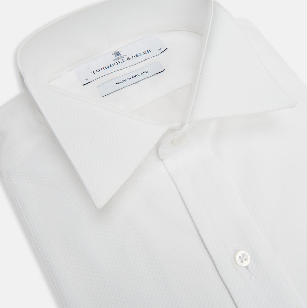 The Turnbull & Asser White Cotton Dress Shirt features a wing collar, double cuffs, and is displayed on a plain white background.