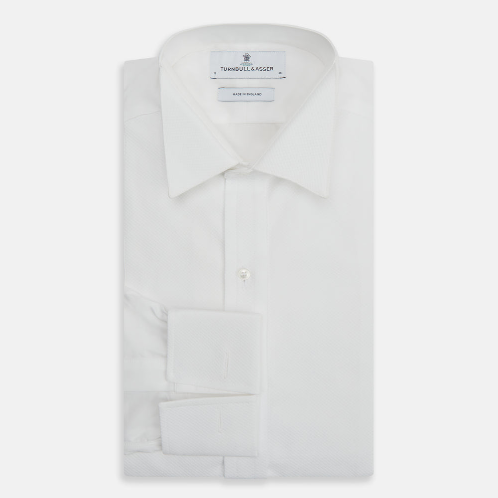 The Turnbull & Asser White Cotton Dress Shirt features a wing collar, double cuffs, and is displayed on a plain white background.