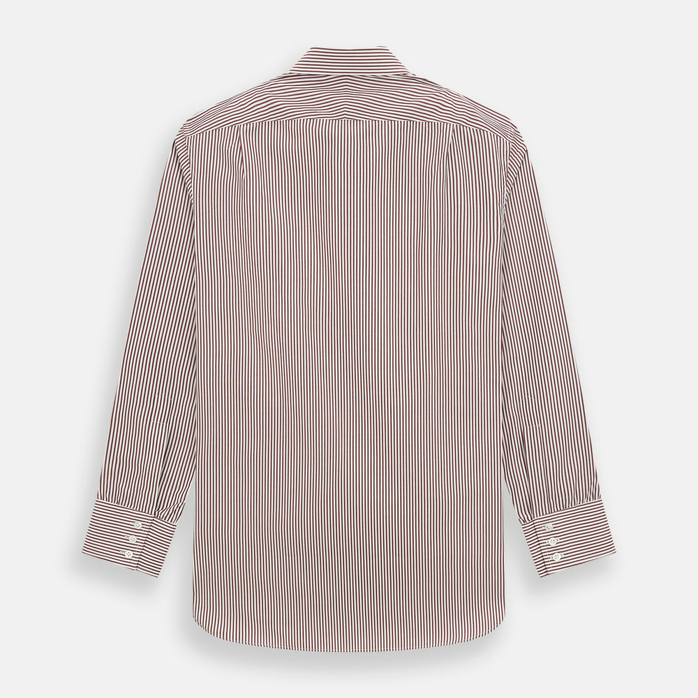The Turnbull & Asser Burgundy Halo Stripe Winston Shirt features long sleeves, a classic T&A collar, buttoned cuffs, narrow vertical burgundy and white stripes, and is crafted from organic cotton. Displayed on a white background.