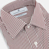 View 2 of product The Turnbull & Asser Burgundy Halo Stripe Winston Shirt features long sleeves, a classic T&A collar, buttoned cuffs, narrow vertical burgundy and white stripes, and is crafted from organic cotton. Displayed on a white background.