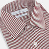 View 2 of product The Turnbull & Asser Burgundy Micro Check Winston Shirt is a long-sleeved, button-up Mayfair fit dress shirt with a collar and buttoned cuffs, featuring a small red and white check pattern and shown on a white background.