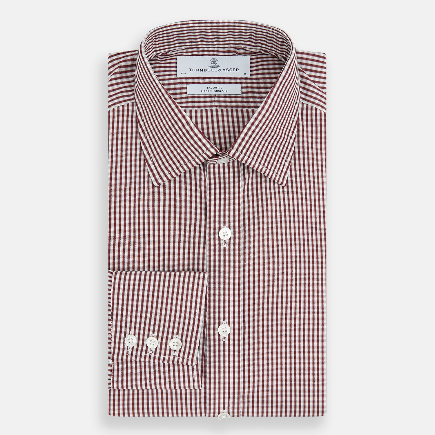 View 5 of product The Turnbull & Asser Burgundy Micro Check Winston Shirt is a long-sleeved, button-up Mayfair fit dress shirt with a collar and buttoned cuffs, featuring a small red and white check pattern and shown on a white background.