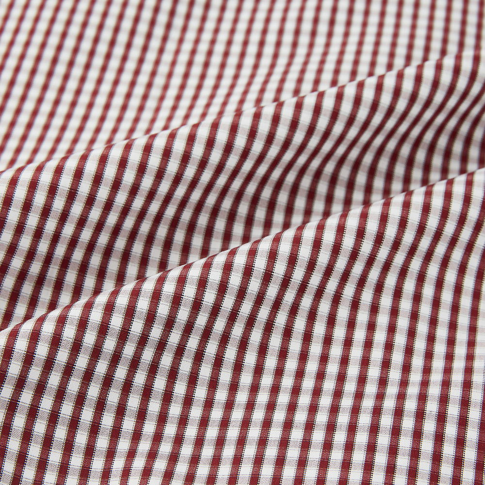 The Turnbull & Asser Burgundy Micro Check Winston Shirt is a long-sleeved, button-up Mayfair fit dress shirt with a collar and buttoned cuffs, featuring a small red and white check pattern and shown on a white background.