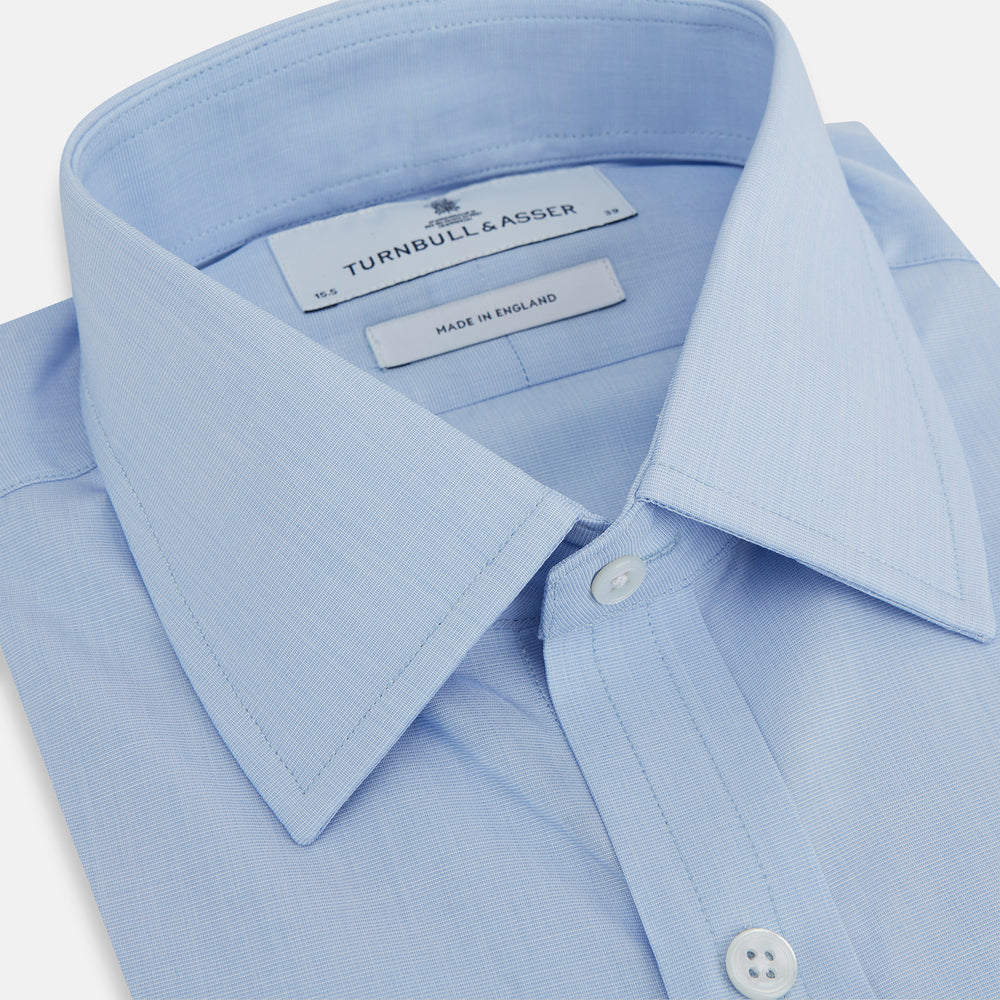 The Turnbull & Asser Light Blue End-on-End Shirt, featuring a T&A collar and 3-button cuffs, is laid flat on a white background—perfect for smart looks or complementing your favorite navy suit.