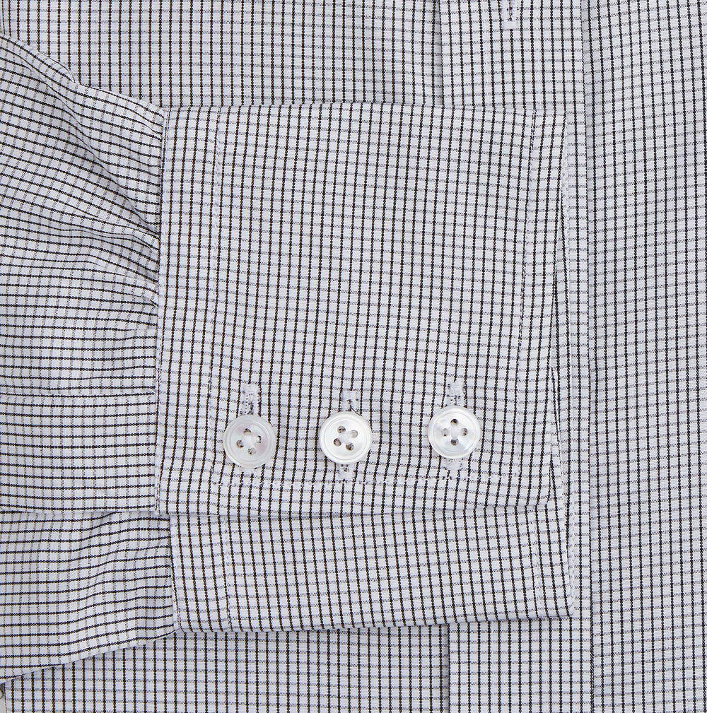 The Turnbull & Asser Dark Blue and White Graph Check Mayfair Shirt is a long-sleeve, button-up shirt with a pointed collar, shown on a plain white background.