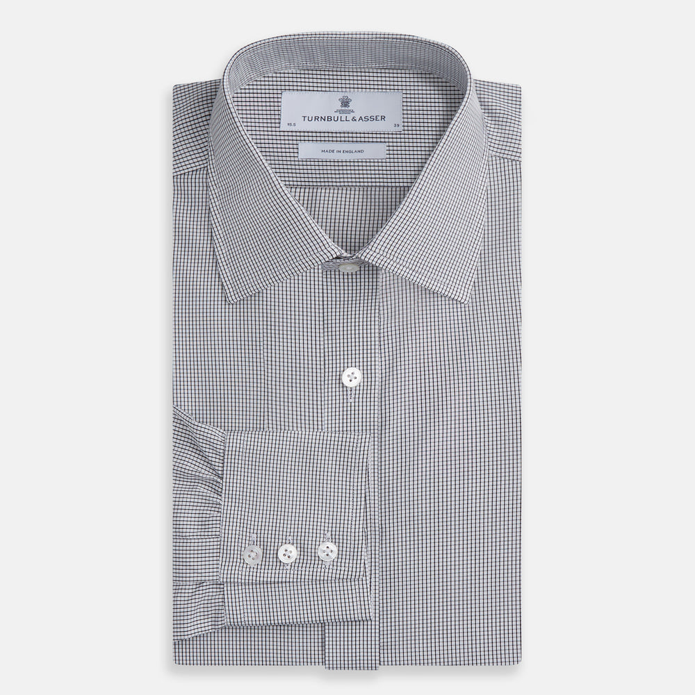 The Turnbull & Asser Dark Blue and White Graph Check Mayfair Shirt is a long-sleeve, button-up shirt with a pointed collar, shown on a plain white background.
