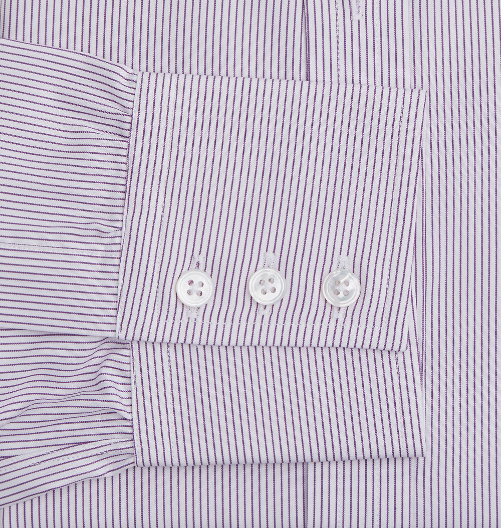 The Purple Pinstripe Mayfair Shirt by Turnbull & Asser is a light purple cotton poplin long-sleeve button-up with white stripes, a pointed collar, white buttons, and cuffed sleeves, shown laid flat on a white background.