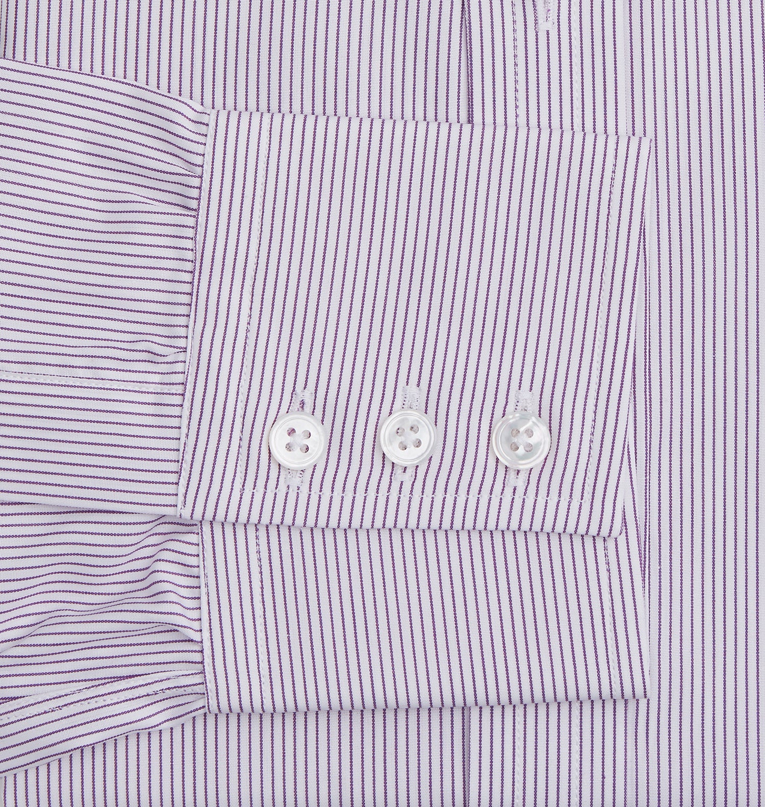 View 3 of product The Purple Pinstripe Mayfair Shirt by Turnbull & Asser is a light purple cotton poplin long-sleeve button-up with white stripes, a pointed collar, white buttons, and cuffed sleeves, shown laid flat on a white background.