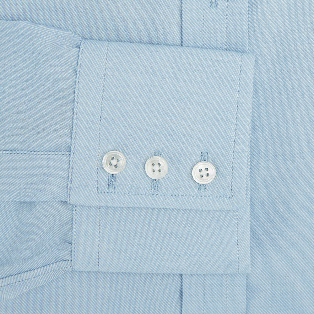 The Turnbull & Asser Blue Cotton Cashmere Mayfair Shirt features long sleeves, a classic collar, buttoned cuffs, and white buttons, shown against a white background.