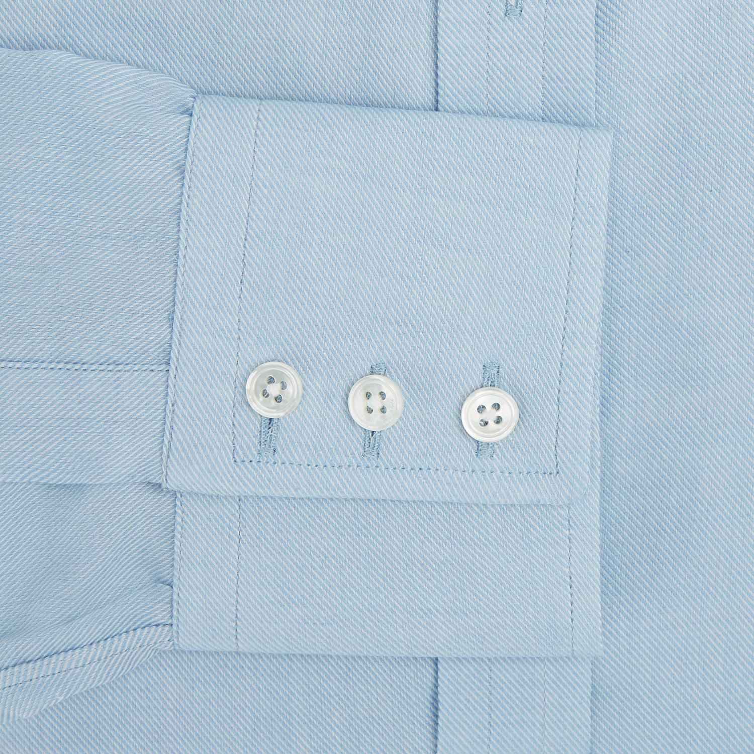 View 3 of product The Turnbull & Asser Blue Cotton Cashmere Mayfair Shirt features long sleeves, a classic collar, buttoned cuffs, and white buttons, shown against a white background.