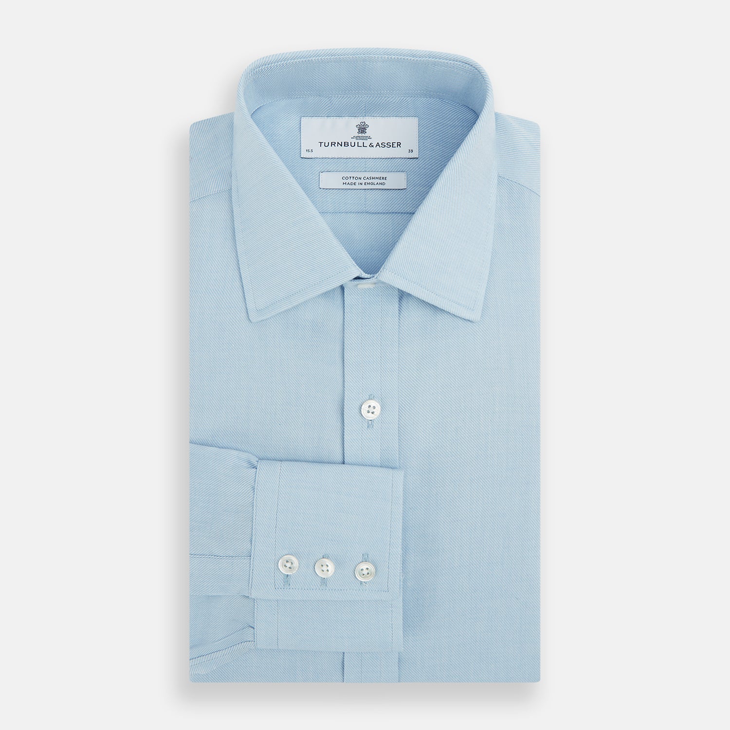 View 4 of product The Turnbull & Asser Blue Cotton Cashmere Mayfair Shirt features long sleeves, a classic collar, buttoned cuffs, and white buttons, shown against a white background.
