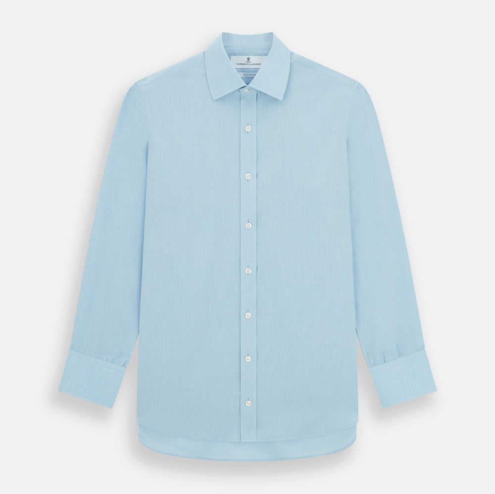 The Turnbull & Asser Blue Cotton Cashmere Mayfair Shirt features long sleeves, a classic collar, buttoned cuffs, and white buttons, shown against a white background.