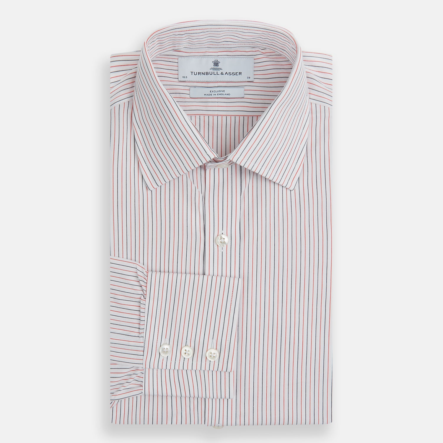 View 4 of product The Turnbull & Asser Red and Navy Pinstripe Mayfair Shirt, an organic cotton long-sleeve button-up with a collar, features thin vertical red and navy pinstripes on white, shown laid flat on a white surface.