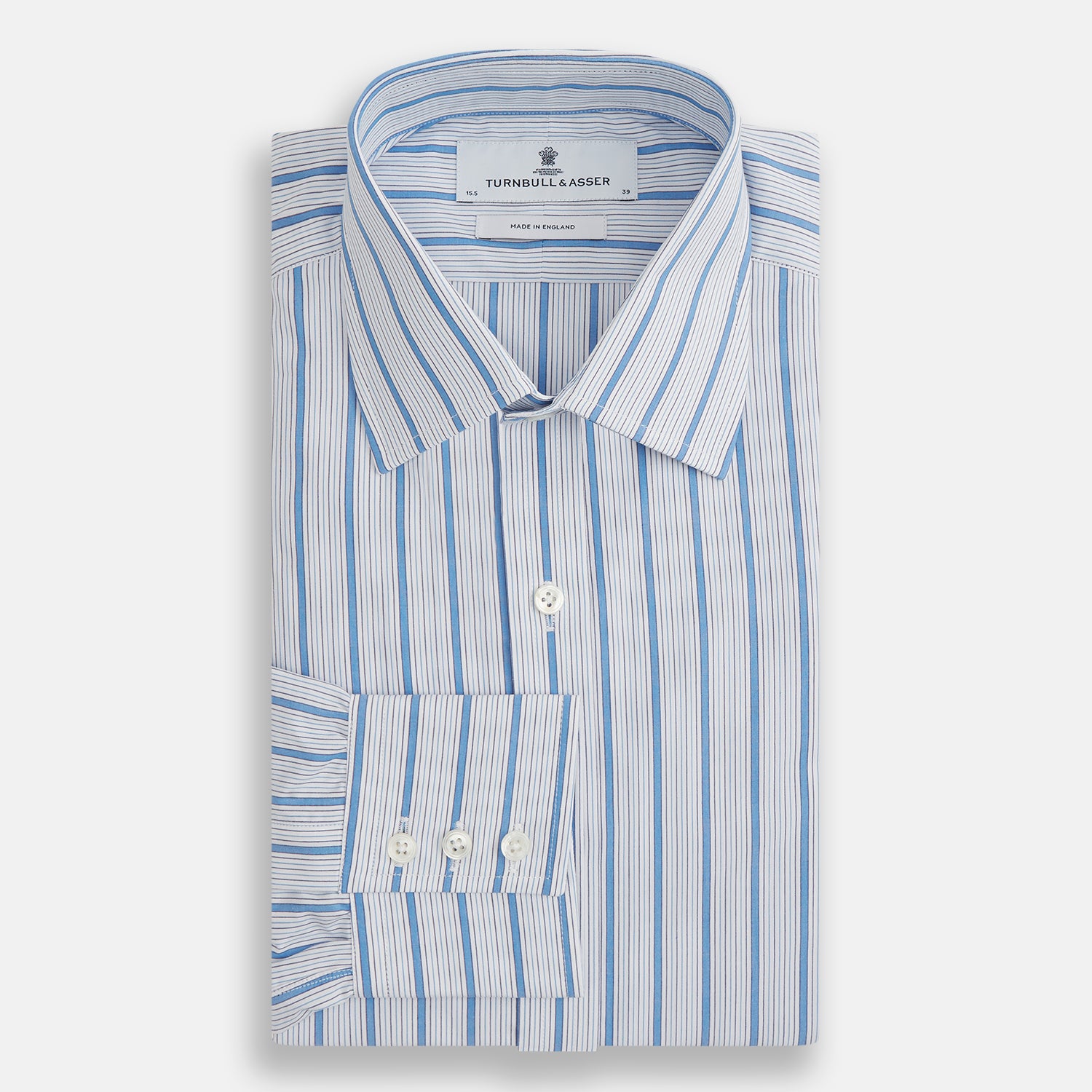 View 4 of product The Turnbull & Asser Blue Multi Track Stripe Mayfair Shirt is a button-up, long-sleeve shirt in white organic cotton with blue vertical stripes, classic collar, and buttoned cuffs.