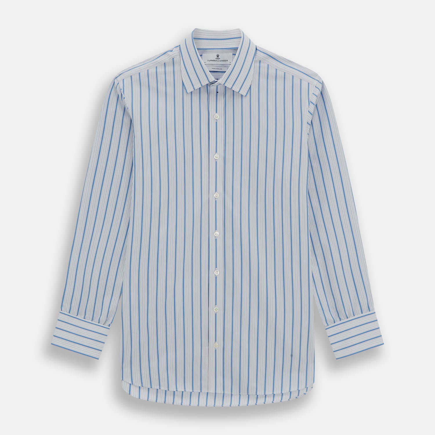 View 1 of product The Turnbull & Asser Blue Multi Track Stripe Mayfair Shirt is a button-up, long-sleeve shirt in white organic cotton with blue vertical stripes, classic collar, and buttoned cuffs.