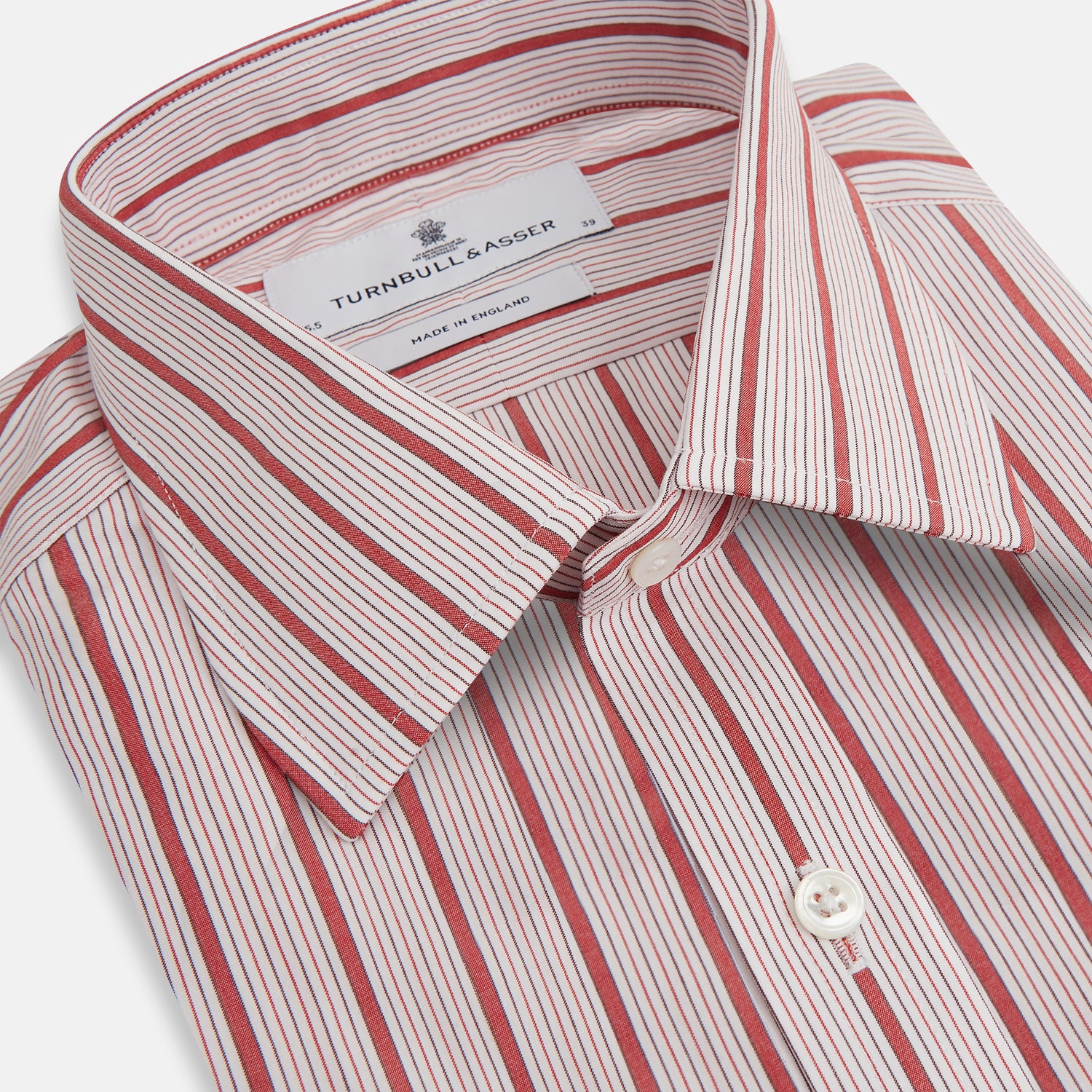 View 2 of product The Red Multi Track Stripe Mayfair Shirt by Turnbull & Asser is a long-sleeved, collared button-up featuring vertical red stripes on white and horizontal red stripes on the cuffs.