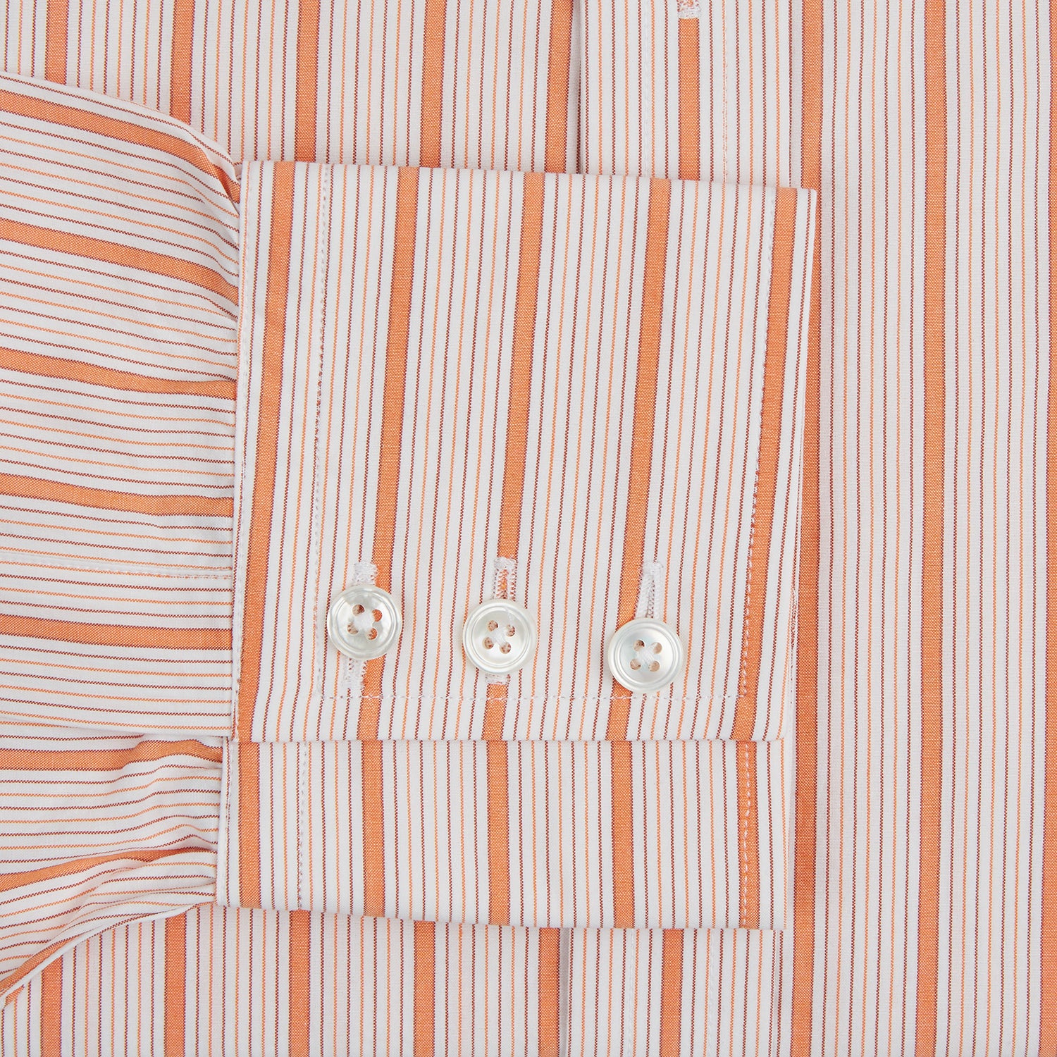 View 3 of product The Orange Graph Overlay Check Mayfair Shirt by Turnbull & Asser is a long-sleeved organic cotton button-up with orange and white stripes, a collar, and wide cuffs—ideal for elevating your wardrobe. Shown against a white background.