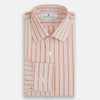 View 4 of product The Orange Graph Overlay Check Mayfair Shirt by Turnbull & Asser is a long-sleeved organic cotton button-up with orange and white stripes, a collar, and wide cuffs—ideal for elevating your wardrobe. Shown against a white background.