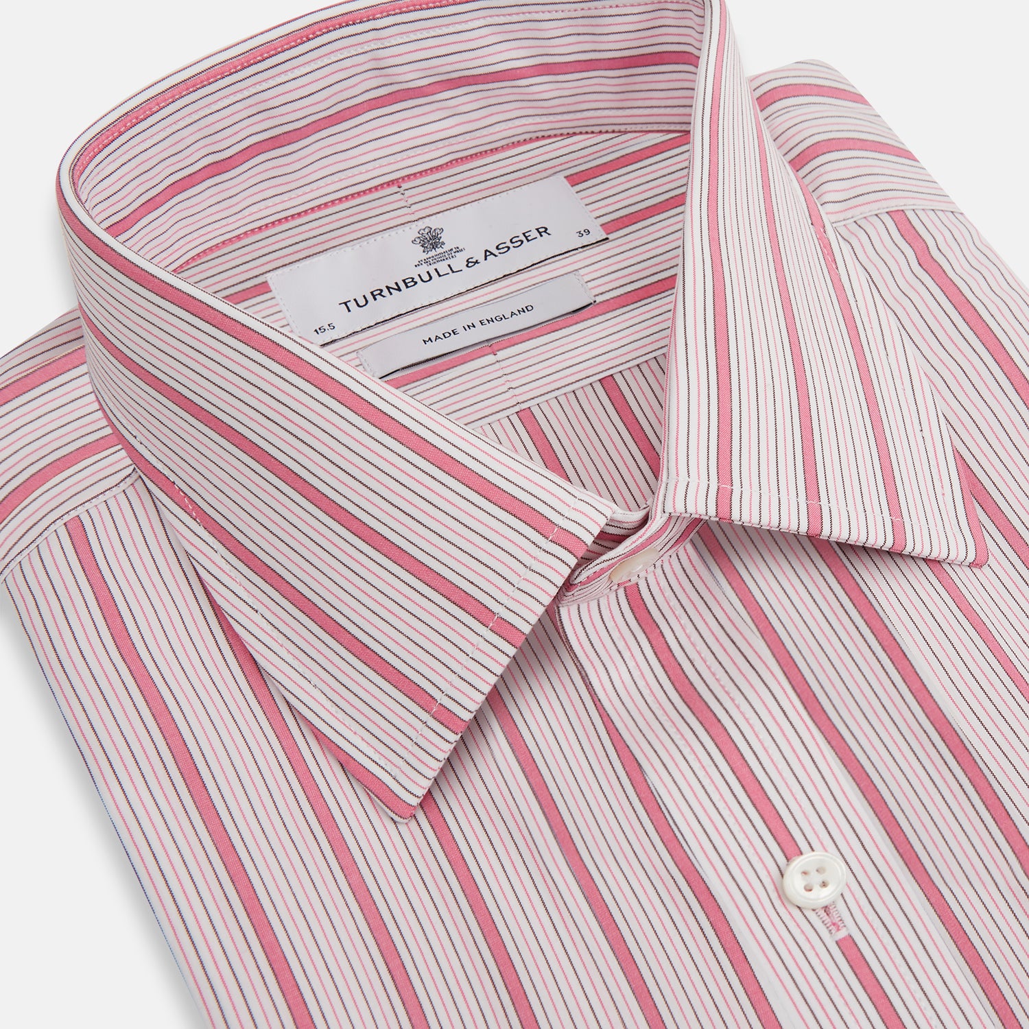 View 2 of product The Turnbull & Asser Pink Multi Track Stripe Mayfair Shirt features long sleeves, a button-down front, classic collar, and buttoned cuffs with red and pink stripes on white, neatly displayed on a light background.