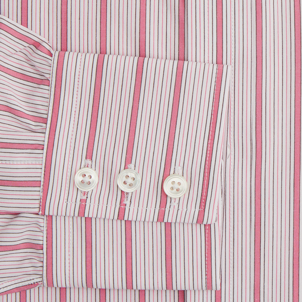 The Turnbull & Asser Pink Multi Track Stripe Mayfair Shirt features long sleeves, a button-down front, classic collar, and buttoned cuffs with red and pink stripes on white, neatly displayed on a light background.
