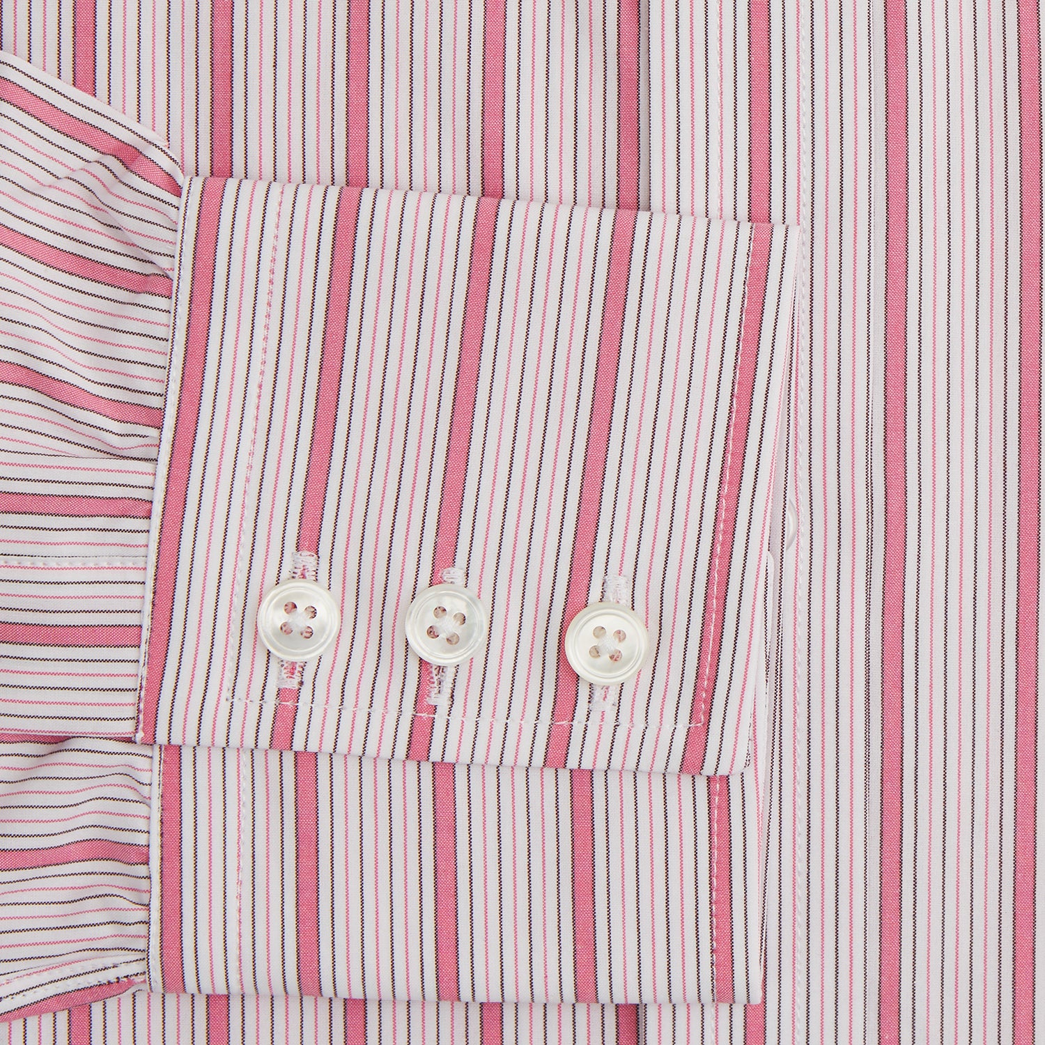 View 3 of product The Turnbull & Asser Pink Multi Track Stripe Mayfair Shirt features long sleeves, a button-down front, classic collar, and buttoned cuffs with red and pink stripes on white, neatly displayed on a light background.