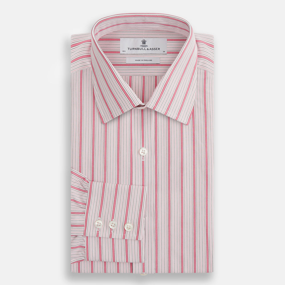 The Turnbull & Asser Pink Multi Track Stripe Mayfair Shirt features long sleeves, a button-down front, classic collar, and buttoned cuffs with red and pink stripes on white, neatly displayed on a light background.