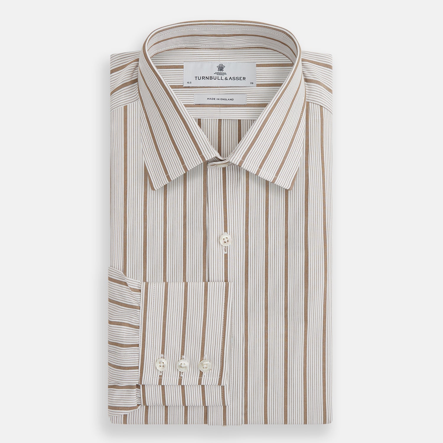 View 4 of product The Brown Multi Track Stripe Mayfair Shirt by Turnbull & Asser is a long-sleeved, collared, button-up in organic cotton with vertical brown and white stripes, classic fit, cuffs, and timeless style—shown on a plain white background.