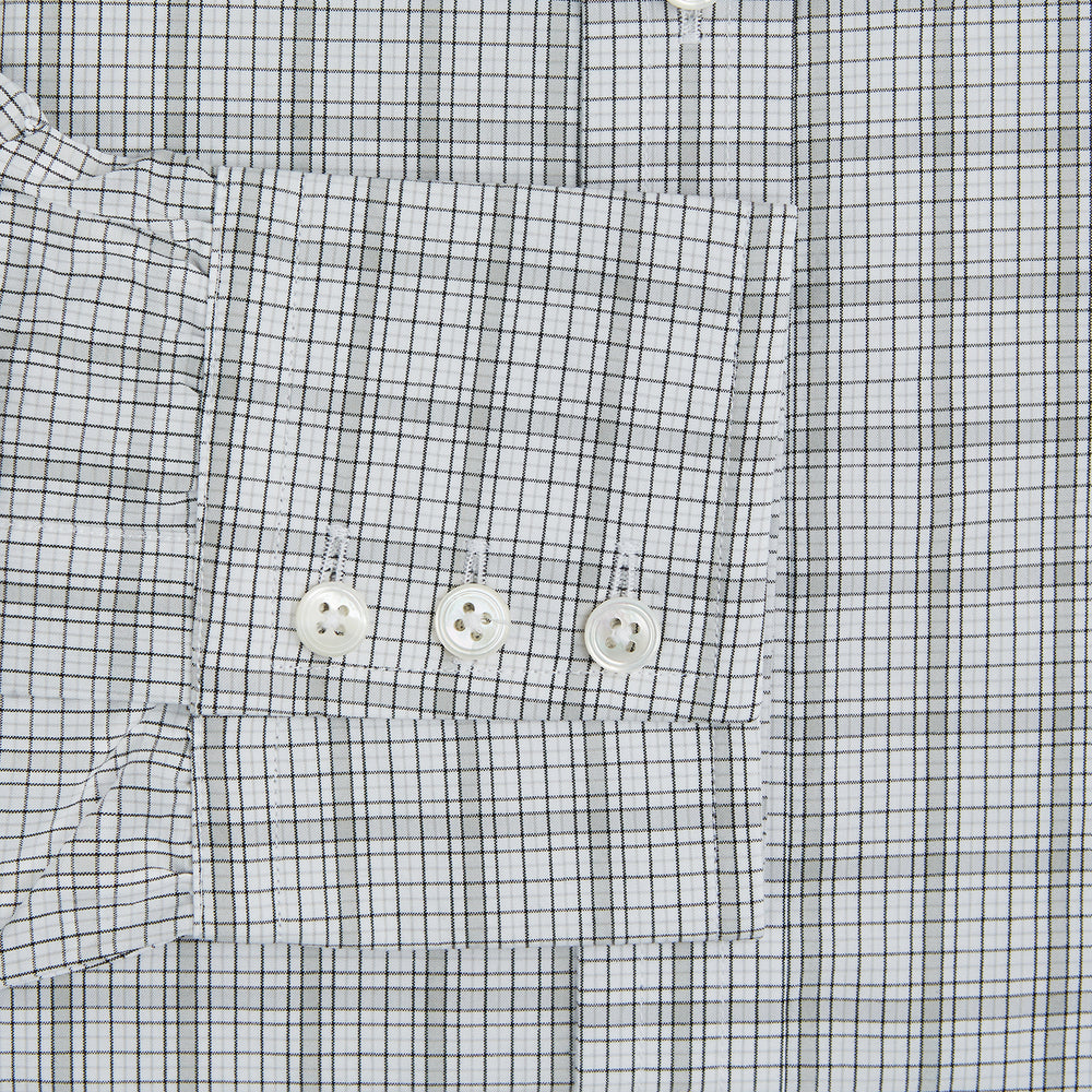 The Turnbull & Asser Grey Fine Multi Graph Check Mayfair Shirt features a breathable cotton fabric, classic T&A collar, white buttons, and a subtle plaid pattern, displayed on a white background.