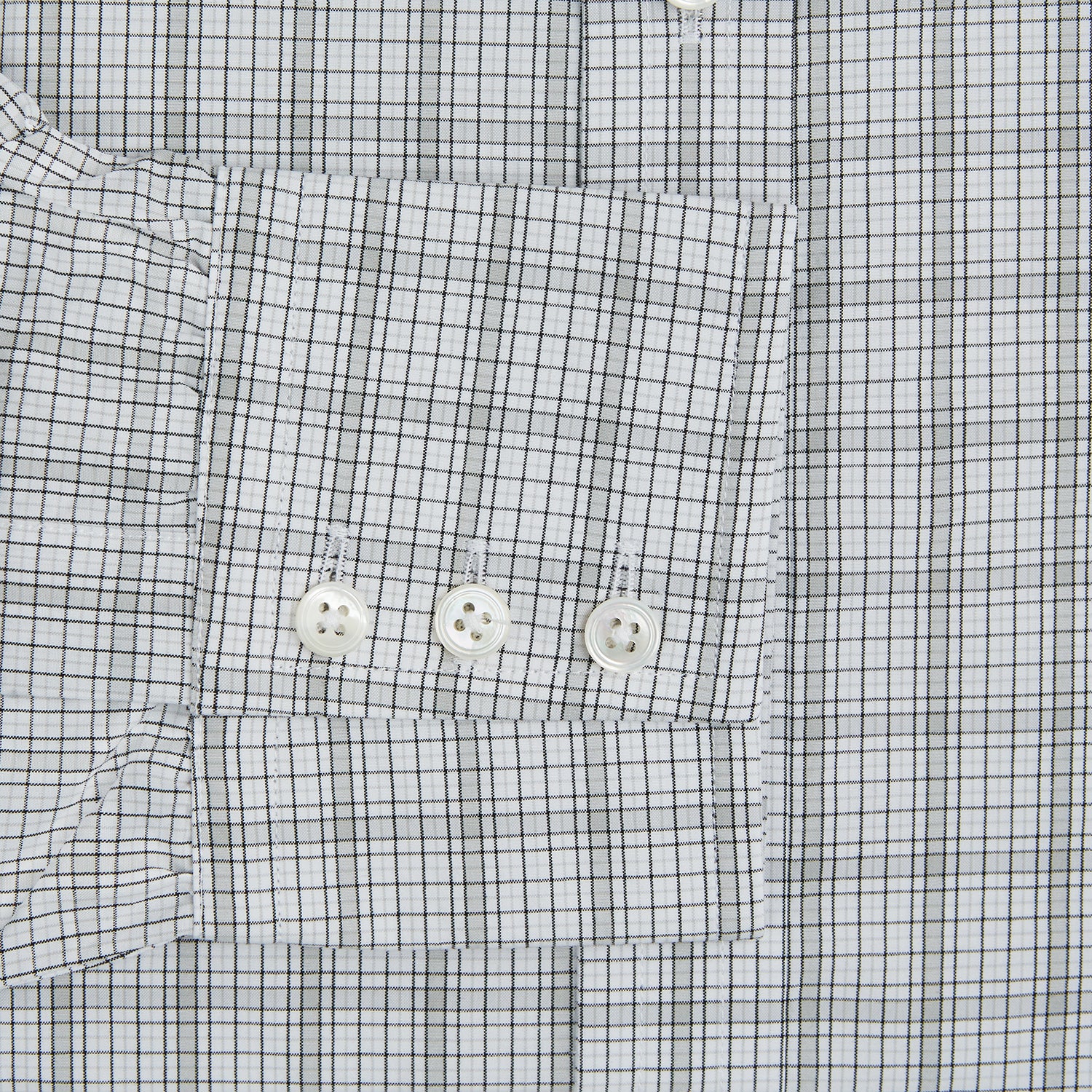 View 3 of product The Turnbull & Asser Grey Fine Multi Graph Check Mayfair Shirt features a breathable cotton fabric, classic T&A collar, white buttons, and a subtle plaid pattern, displayed on a white background.