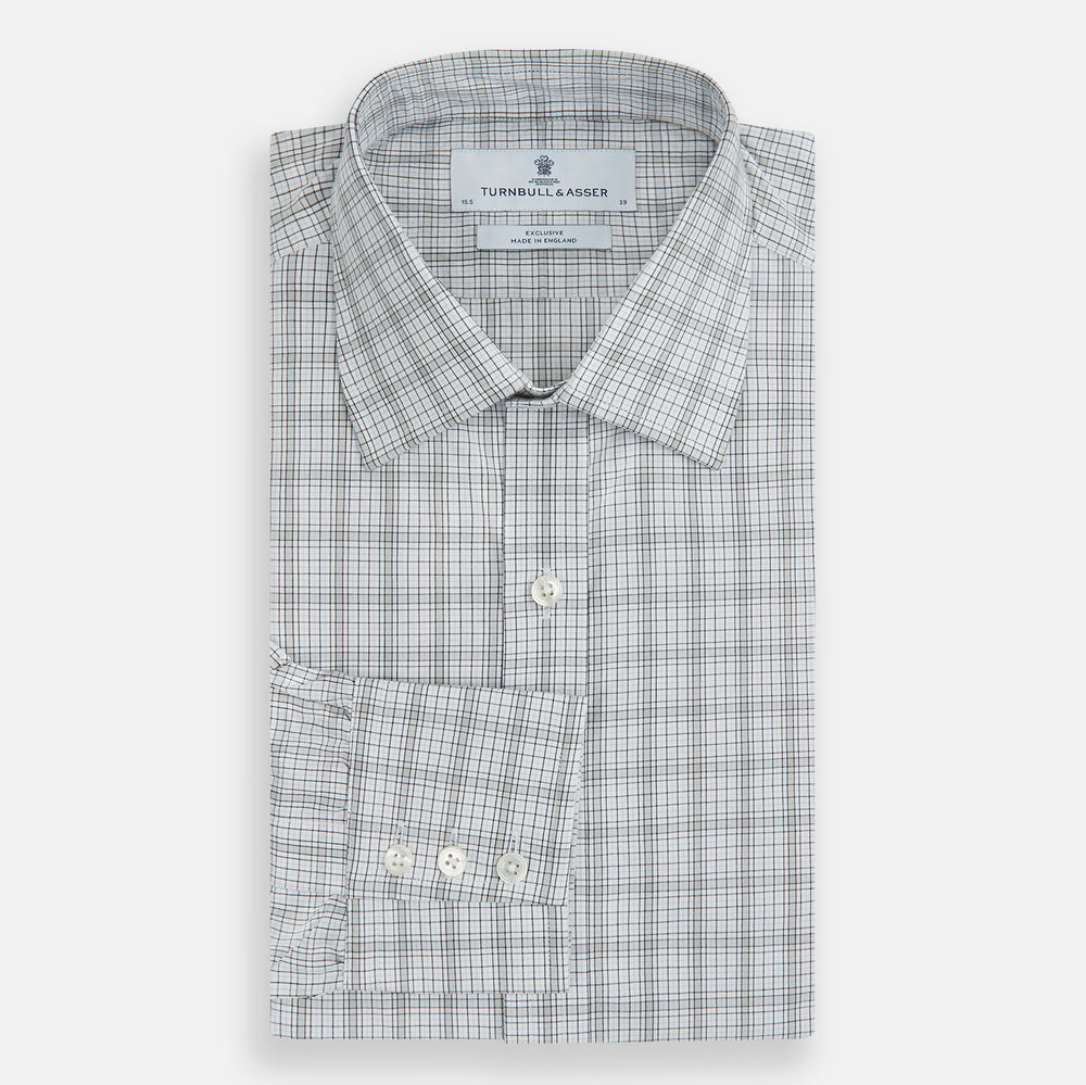 The Turnbull & Asser Grey Fine Multi Graph Check Mayfair Shirt features a breathable cotton fabric, classic T&A collar, white buttons, and a subtle plaid pattern, displayed on a white background.