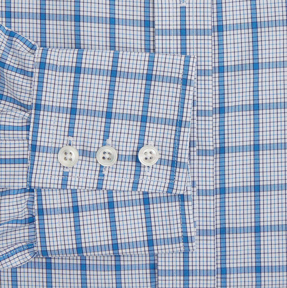 The Turnbull & Asser Blue Graph Overlay Check Mayfair Shirt features long sleeves, a spread collar, buttoned cuffs, and a blue and white plaid pattern, shown against a plain white background.